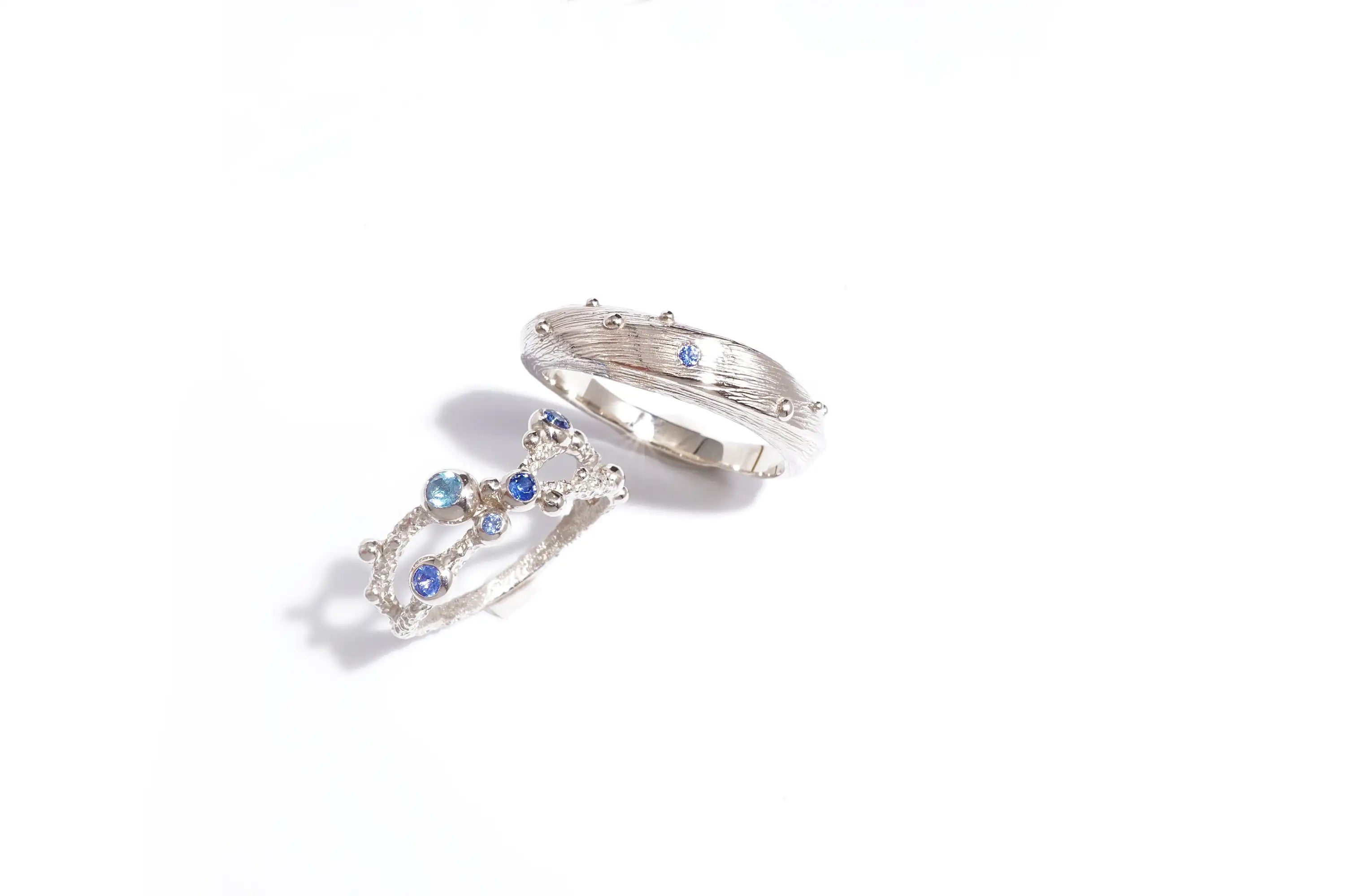 Chia Jewelry unique handmade custom blue sapphire gold wedding rings inspired by sea. With special design and texture.